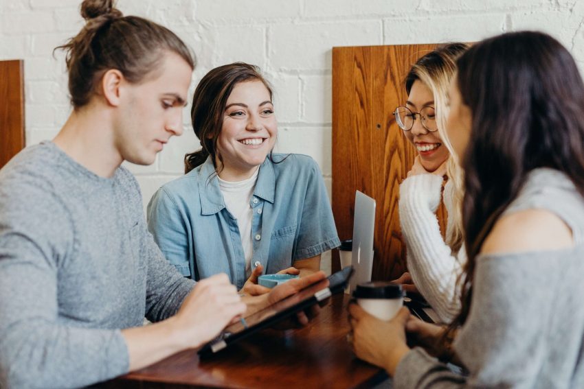 Four University of the People students at a cafe table