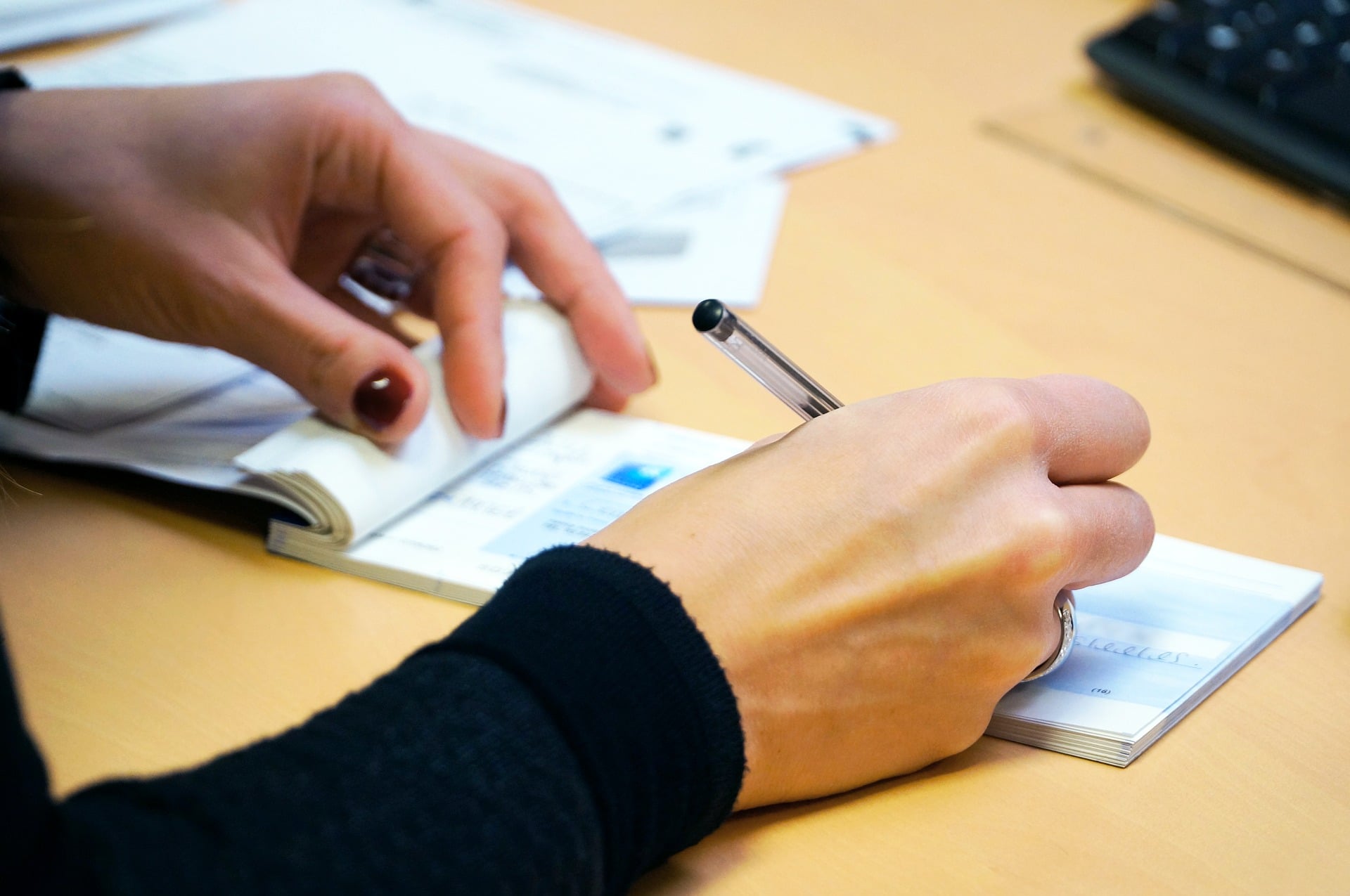 Healthcare administrator writing a check