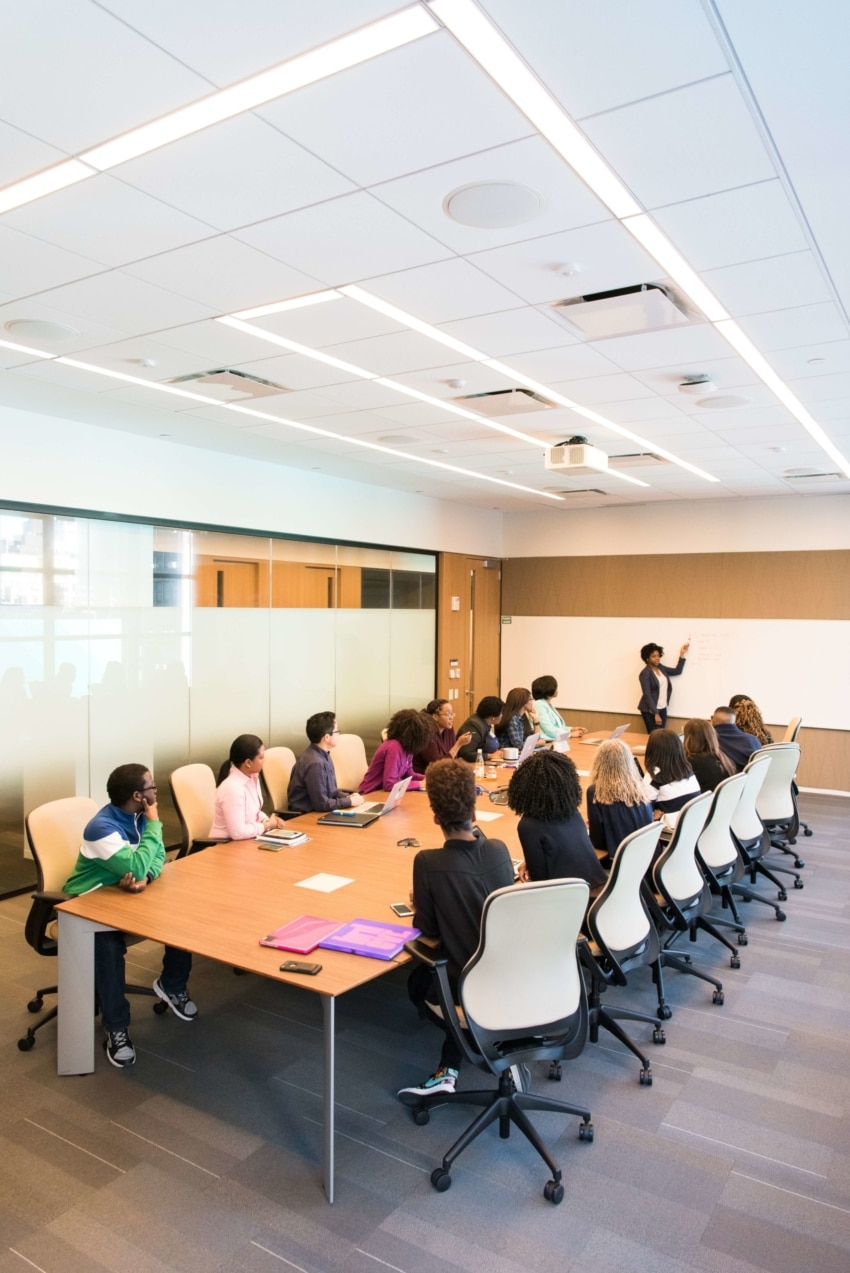 “Woman practicing her speech in front of colleagues”