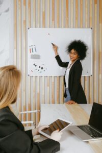 Teacher and principal meeting to share school plan on whiteboard 