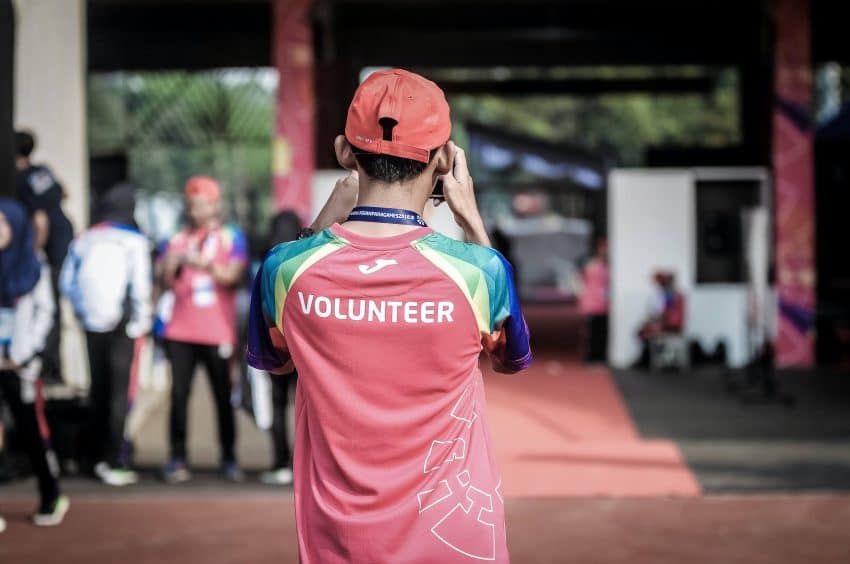 Guy in red shirt volunteering on his gap year