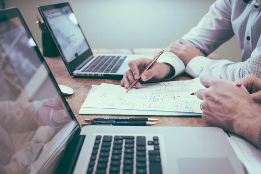 Accountant at a desk with client