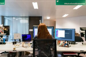 woman on computers working on cyber-physical systems 