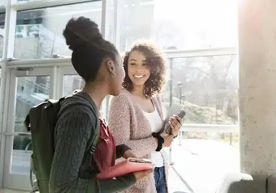 two female college students interacting with each other