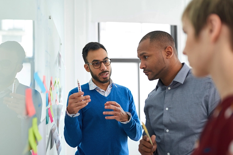 three strategic managers exchanging ideas with each other