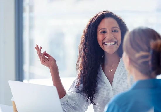 a female HR professional explaining something to a colleague