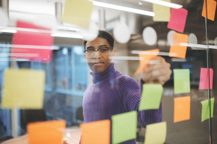 a young corporate leader focused at his task board