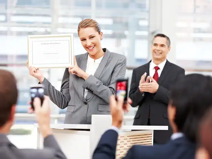 a young woman celebrting having earned a business certificate online