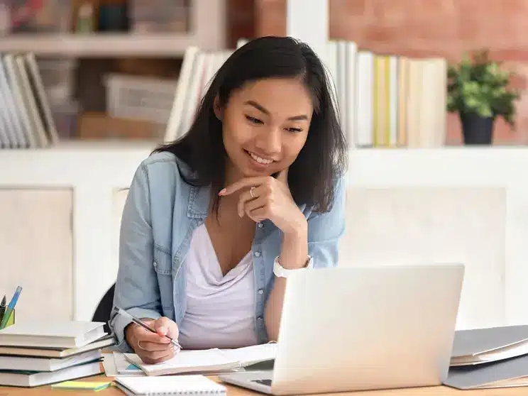 female computer science student working on her laptop