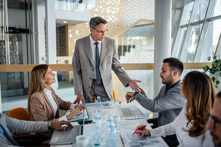 strategic managers discussing something seated around a table