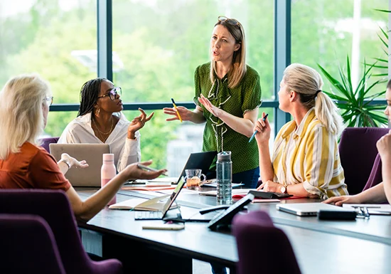 business leaders discussing business ethics sat across a table