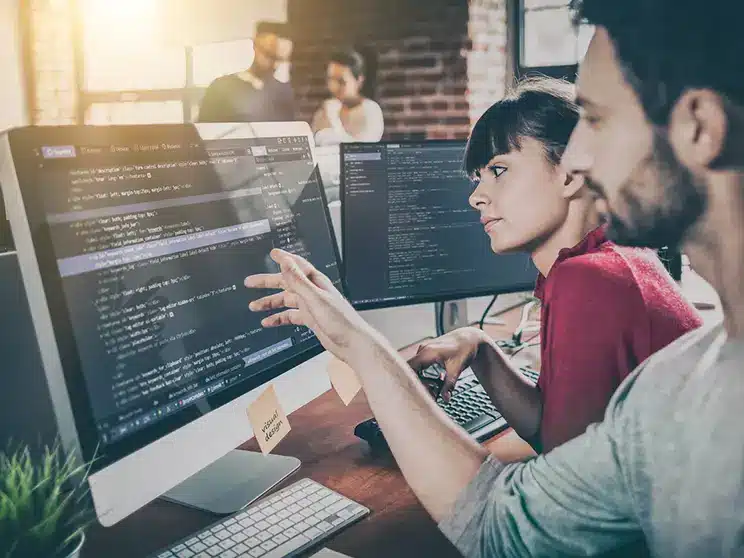 two young computer programmers coding together